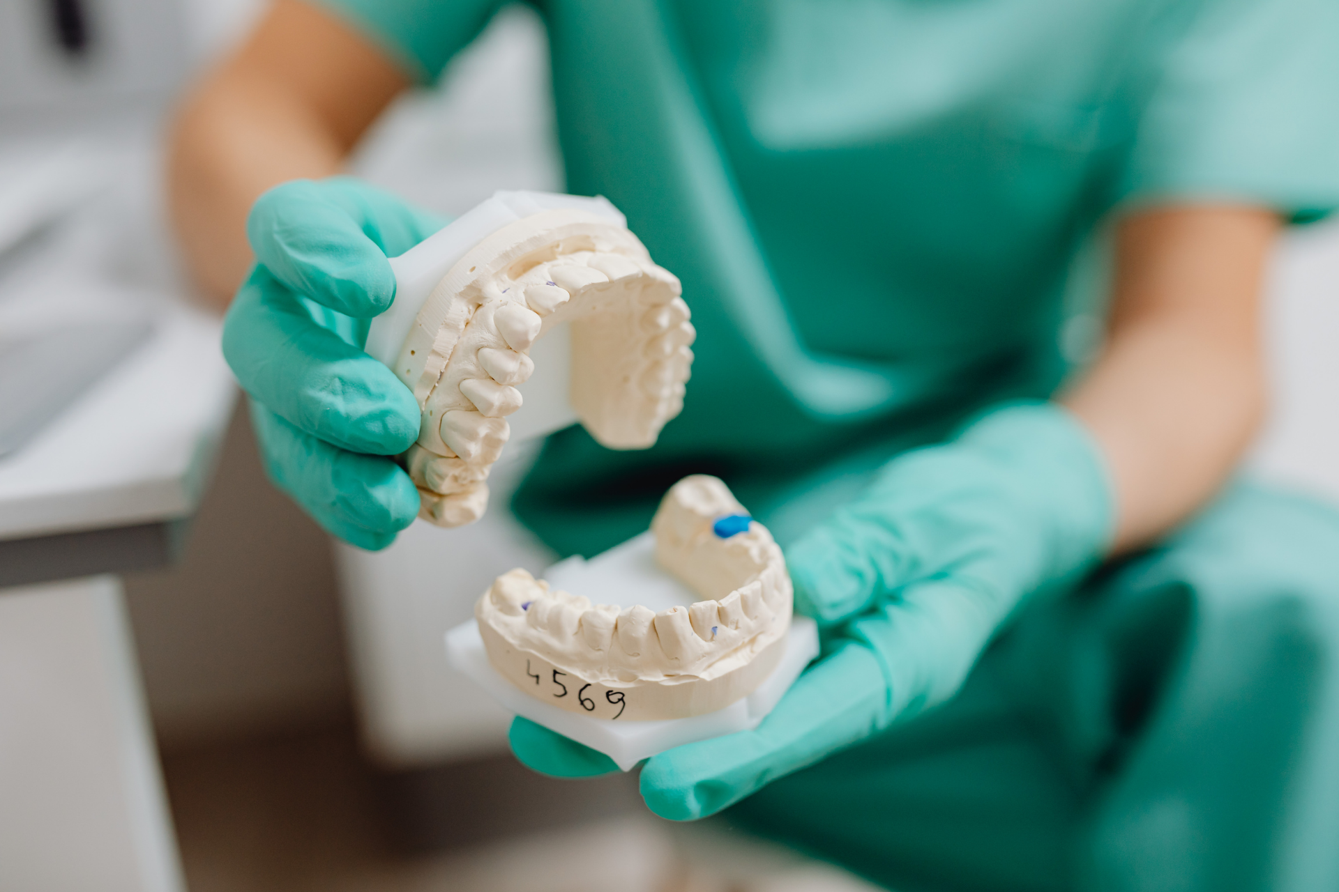 Before-and-after of a woman's smile. The right photo shows a brighter, wider smile with a dental enhancement.